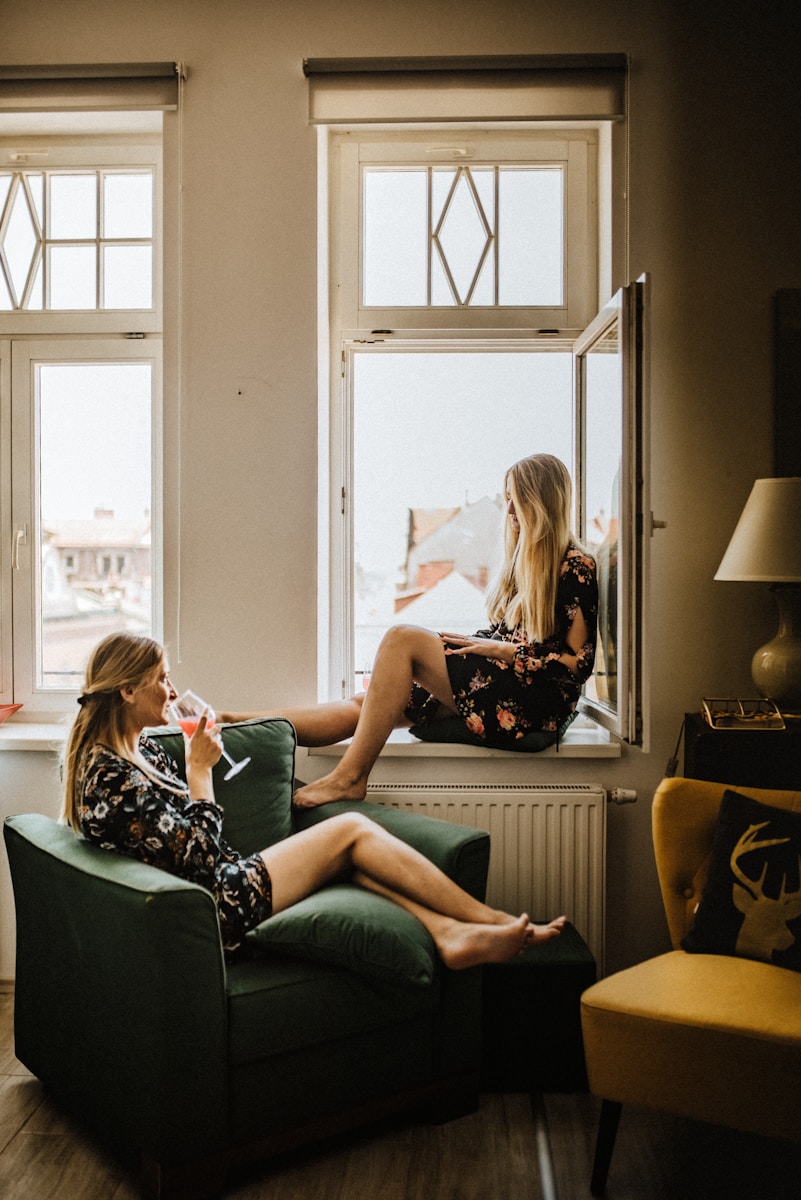 Photo by Kinga Howard 2 women sitting on sofa