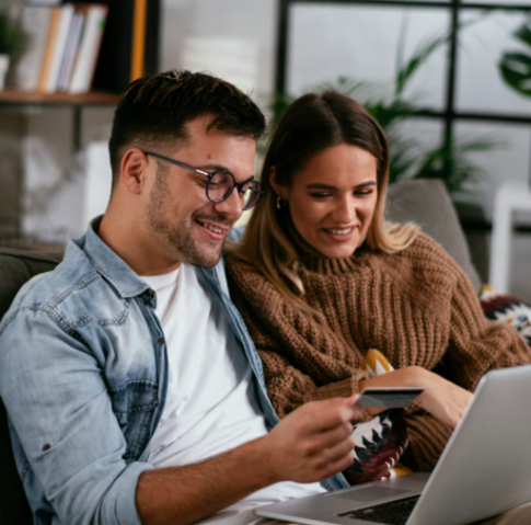 Young professional couple managing relocation expenses, rental deposits, and monthly living budget on a laptop in Bicester