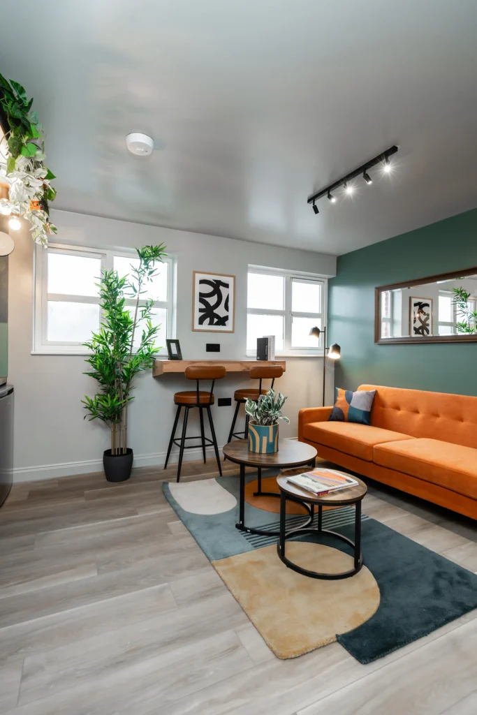 Open-plan living room with orange sofa